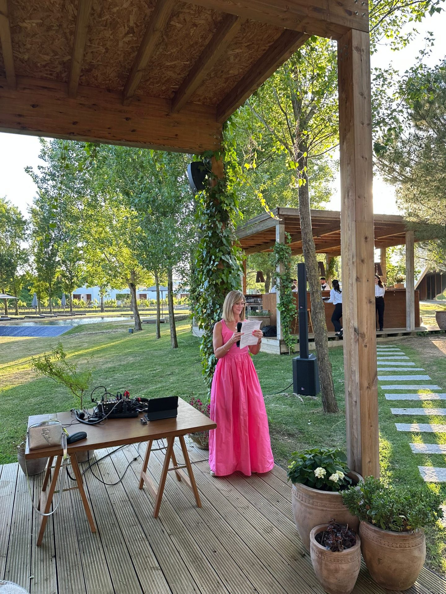 Kirsty delivering an outdoor ceremony in a pink dress